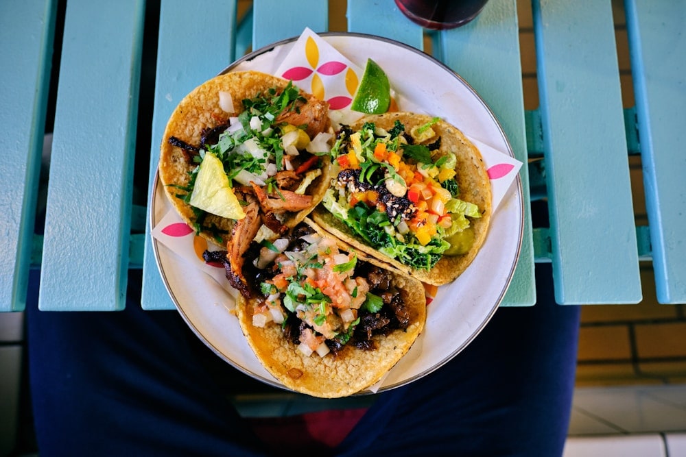 Mexican tacos filled with meat, vegetables, herbs and lime